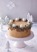 Winter celebration cake with chocolate icing and rosemary