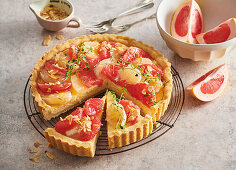 Grapefruit tart with vanilla cream and flaked almonds