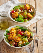 Mixed salad with chicken nuggets and nuts