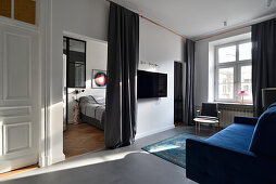 Modern flat in old building with view of bedroom from living room