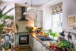 Kitchen with fresh vegetables on sideboard