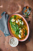 Hot curry with egg, peas, mangetout and curry leaves