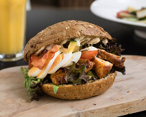 Wholemeal sandwich with grilled chicken, bacon and egg