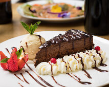 Chocolate cake with cream and vanilla ice cream