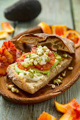 Sandwich with avocado, blood orange and sprouts