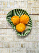 Peeled oranges in ceramic bowl