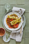 Fennel braised in saffron anise stock with roasted tomatoes and mountain lentils