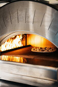 Pizza in the burning pizza oven