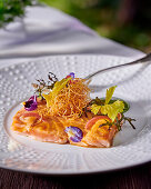 Teriyaki salmon with deep-fried noodles and herbs