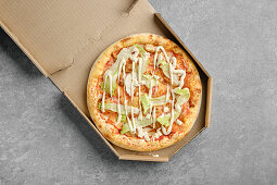 Vegetarian pizza with iceberg lettuce, tomatoes and mayonnaise
