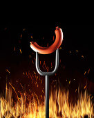 Sausage on fork over flames