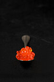 Salmon caviar on a spoon