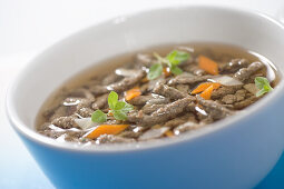 Liver spaetzle soup with carrots and oregano
