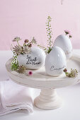 Porcelain egg vases with flowers and herbs