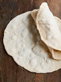 Fresh wheat flatbread on a wooden table