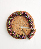 Giant chocolate biscuit with colourful crumble topping