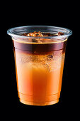 Espresso tonic with sea buckthorn syrup in a plastic cup