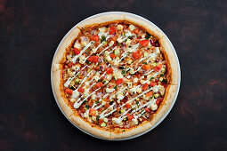 Vegetarian pizza with feta, courgette, tomato and cucumber