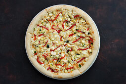 Pizza with chicken, peppers, courgette and feta cheese