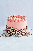 Pink layer cake with chocolate decoration