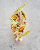 Caesar salad with grilled chicken and poached egg