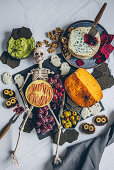 Halloween cheese platter with various cheeses and decoration