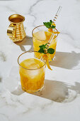 Passion fruit and tequila cocktail with lemon zest and mint