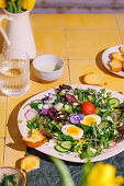 Spring salad with radishes, flowers and egg