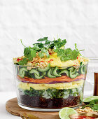 Asian layered salad with rice, vegetables and pineapple