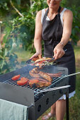 Wife grills hot dogs and spare ribs