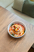 Turkish eggs with yoghurt and simit (Turkish bagel)