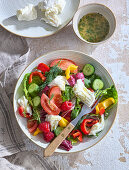 Summer mozzarella vegetable salad with tomatoes, cucumber and raspberries