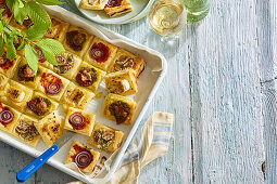 Piquant puff pastry canapés with various toppings