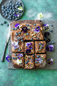 Chocolate sheet cake with blueberries and edible flowers