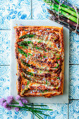 Puff pastry tart with ham and green asparagus