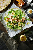 Tortilla wrap with salmon, egg, rocket and mustard-dill sauce