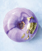 Purple mirror glaze donut with edible gold leaf