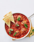 Pizza meatballs in tomato sauce with bread crisps