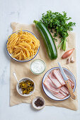 Ingredients for spaghetti with zucchini and bacon