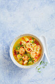 Soup with fried rice, prawns, sweetcorn and peas