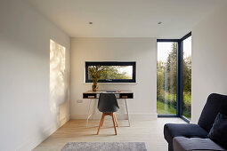 Study with desk and view of the garden, large corner windows