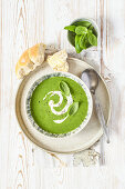 Creamy spinach soup with cream and fresh basil