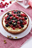 Berry tart with vanilla cream and pistachios