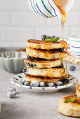 Blueberry pancakes with maple syrup and fresh blueberries