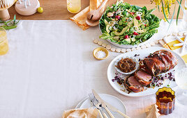 Roasted beef wrapped in prosciutto with onion marmalade and salad