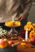 Apple cake with icing and autumnal decoration