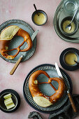 Breakfast scene with pretzel, butter and coffee