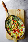 Potato and asparagus pan with cherry tomatoes and lemon