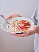 Overnight oats with nectarine slices and coconut flakes