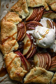 Apple galette with a scoop of vanilla ice cream and caramel sauce